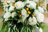 a bright wedding bouquet of white blooms, lots of various greenery and kumquats is a lovely idea for a spring or summer wedding