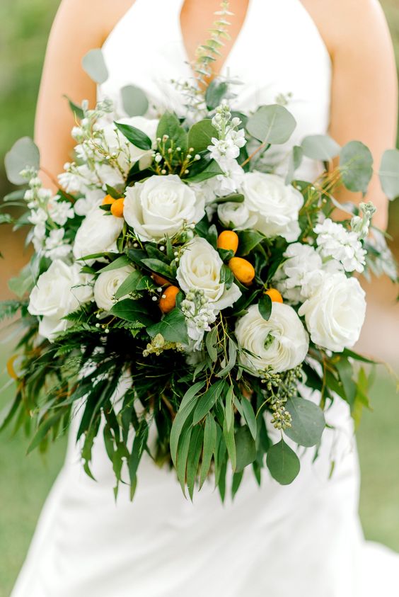 a bright wedding bouquet of white blooms, lots of various greenery and kumquats is a lovely idea for a spring or summer wedding