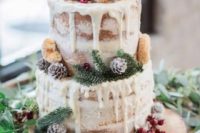 a chic winter woodland wedding cake, a naked one with creamy drip, donuts, pinecones and evergreens plus berries
