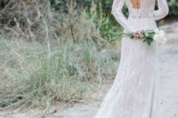 a fitting lace wedding dress with long sleeves, an open back and a train is very chic and refined
