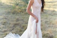 a fully embellished A-line wedding dress with a V-neckline and no sleeves is super glam