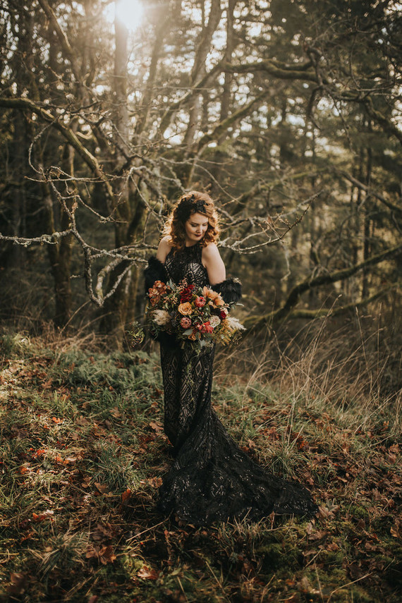 a gorgeous black lace embellished mermaid wedding dress with a halter neckline and a train plus a black faux fur coverup