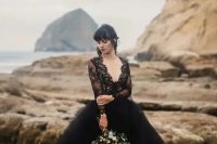 a gorgeous wedding dress with a black lace bodice with a deep V-neck and long sleeves and a layered tulle skirt