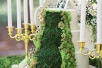 a gorgeous woodland wedding cake with moss and grass decor and a photo topper is a unique idea