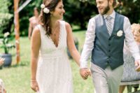 a lace A-line wedding dress with a V-neckline, no sleeves and an A-lien skirt for a boho backyard wedding