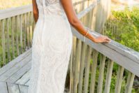 a lace sheath wedding dress with no sleeves, a high neckline and a back on buttons for a beautiful and simple look