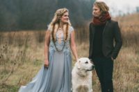 a light blue wedding dress with a lace bodice, cap sleeves and a flowy skirt for a winter woodland wedding