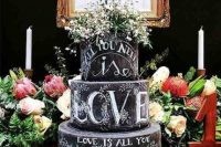 a lovely chalkboard wedding cake with chalking and white blooms on top is a fantastic idea for a rustic, relaxed or some other wedding