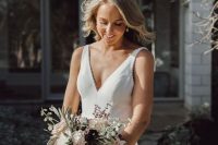 a minimalist plain mermaid wedding dress with an embellished rim, a V-neckline and no sleeves is a beautiful and chic idea