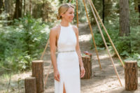 a modern plain halter neckline sheath wedding dress with a silver belt and dark green shoes with ties