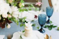 a naked individual cake topped with a white bloom is a stylish and chic idea for a romantic wedding
