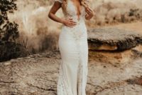 a sexy fitting plain and lace wedding dress with a plunging neckline, cap sleeves and a train