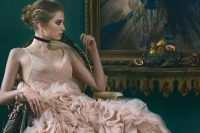 a sophisticated bridal look with a dusty pink wedding dress with a draped bodice and a V-neckline, a ruffle skirt, floral print lace up boots and a black choker