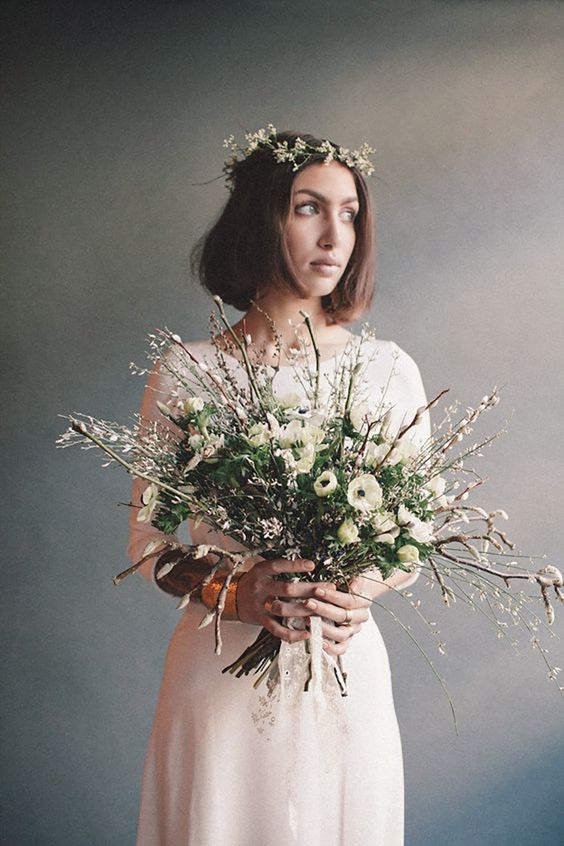 a spring wedding bouquet with willow, white blooms and greenery for a spring woodland bride