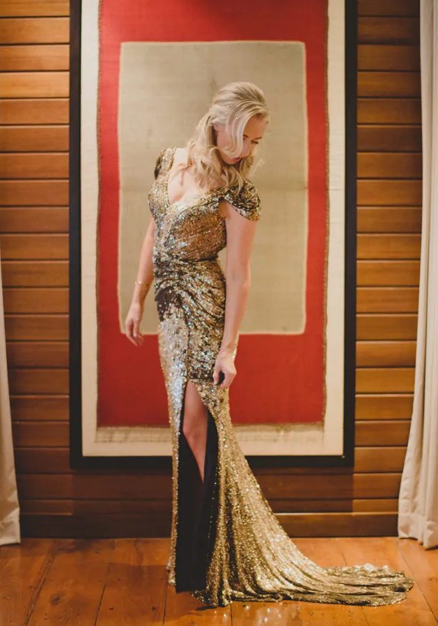 a super elegant gold sheath wedding dress with a deep V-neckline, cap sleeves and a side slit for a glam feel