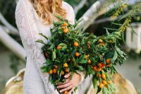 a super lush and bold wedding bouquet composed of lots of greenery and kumquats is a fantastic idea to rock
