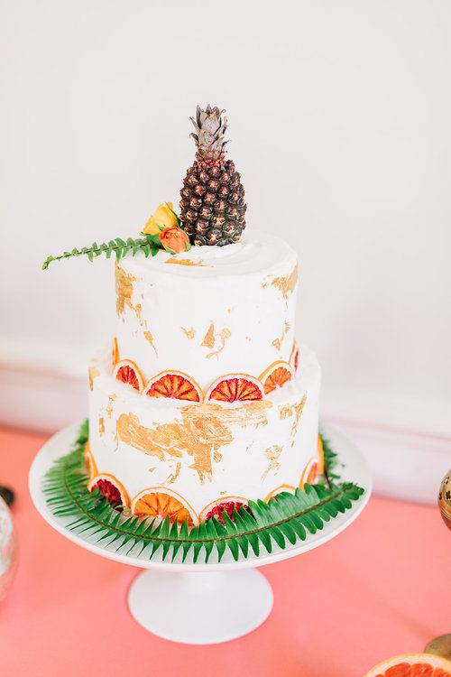 a tropical wedding cake with dried citrus slices, ferns, a mini pineapple on top is a fun and cool idea