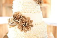 a vintage rustic wedding cake with sleek and ruffled tiers, burlap blooms and a wooden topper