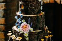 a woodland wedding cake imitating wood cuts, with fresh blooms and fake mushrooms looks very real