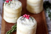 mini lemon frosted wedding cakes with berries and greenery for a Christmas or winter wedding