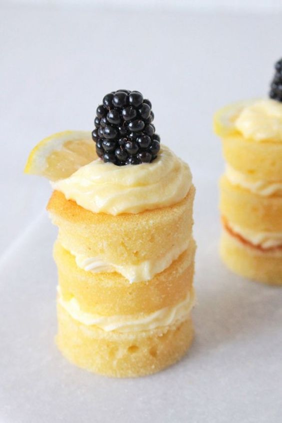 naked lemon chiffon individual cakes with frosting, blackberries and lemon slices are delicious and refreshing