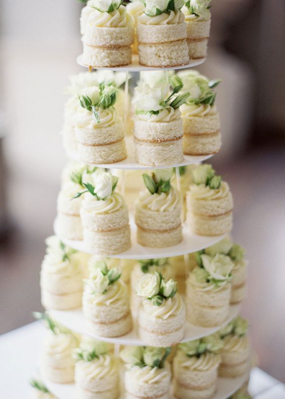 naked vanilla individual wedding cakes with cream and white roses for a beautiful neutral wedding