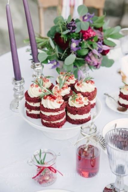 red velvet individual cakes topped with greenery and pomegranate are delicious desserts for a boho wedding