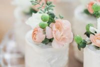 textural buttercream individual wedding cakes topped with berries and white and blush blooms
