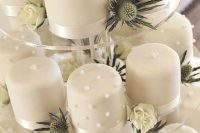 white mini cakes with edible pearls and beads are amazing for a refined neutral wedding