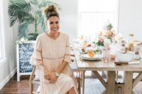 a blush boho midi dress with lace inserts, long sleeves and elegant white sandals for a boho bridal shower at home