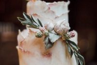 a blush textural wedding cake with gold leaf, fresh blooms and leaves is a beautiful and exquisite idea