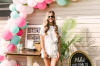 a casual summer bridal shower look with a white top and shorts, white heels with straps and sunglasses