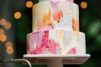 a colorful textural wedding cake in pink, coral, yellow and orange plus gold splashes is very chic