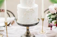 a delicate neutral textural wedding cake with floral patterns is a very refined and chic idea to go for