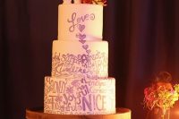 a pretty bright wedding cake with purple graffiti, with creative toppers and bright sugar blooms on top is a gorgeous idea for a modern wedding