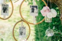 a real tree with fresh blooms in vases and candles plus family photos attached to embroidery hoops