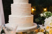 a textural white buttercream wedding cake is a simple and elegant dessert idea for a rustic or modern wedding