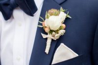 a timelessly elegant groom’s look with a navy suit, a white shirt, a navy bow tie, a white handkerchief to refresh the look and a neutral floral boutonniere