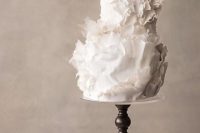 a white sculptural wedding cake with much texture is a beautiful and refined idea to rock