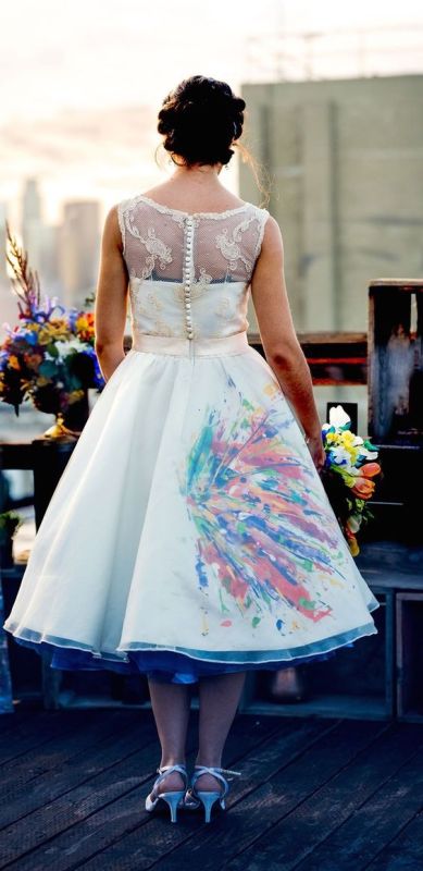 an A-line midi wedding dress with bold graffiti detailing and colorful lining is a cool and creative idea to rock the brights