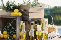 an olive oil tasting table with olive branches and lemons for decorating with a Mediterranean feel