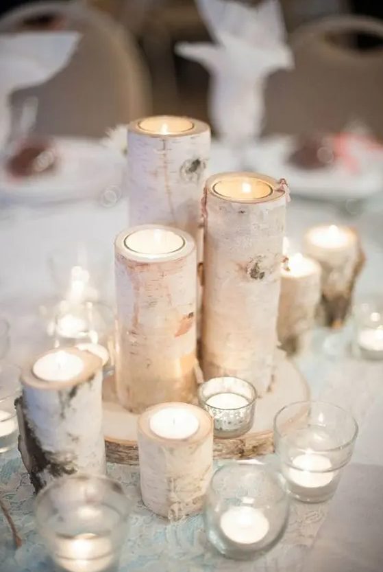 birch candle holders placed on a birch slice and surrounded with additional candles