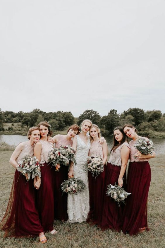 chic fall bridesmaid outfits with neutral cap sleeve lace crop tops and burgundy tulle maxi skirts plus a bold lip