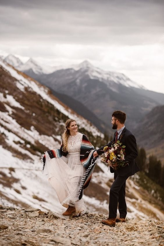 comfy brown boots and a striped folksy coverup for a boho mountain elopement