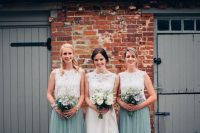 elegant bridesmaid outfits with matching sleeveless whiote lace tops and seafoam green tulle maxi skirts for a garden wedding