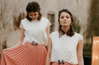 mismatching boho lace cap sleeve crop tops and peachy pink plated midi skirts with pretty bows for a boho wedding