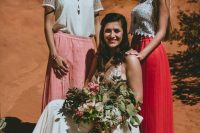 mismatching boho lace tops and a pink and a coral baxi skirt for a boho chic and bold wedding in the desert