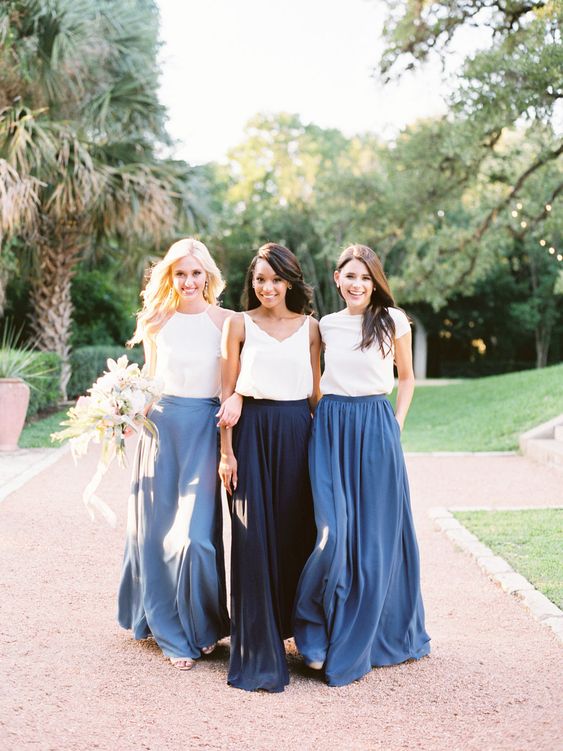 mismatching white plain tops and blue, royal blue and navy flowy maxi skirts for a relaxed summer wedding by the sea