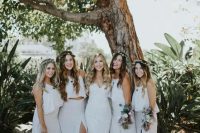neutral summer bridesmaid looks with spaghetti strap crop tops and white maxi skirts with slits for a summer boho wedding