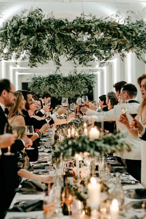 olive greenery chandeliers over the tablescape will substitute wedding centerpieces and table runners and make it fresh